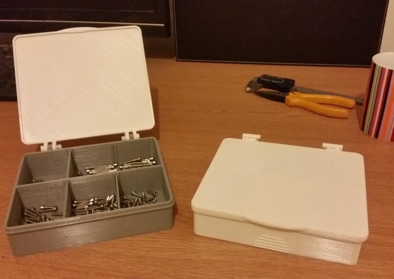 Multi-compartment storage box with hinged lid.