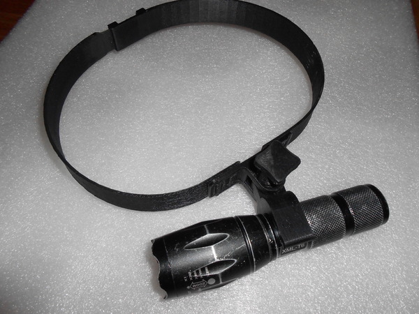 Flashlight holder on a head.