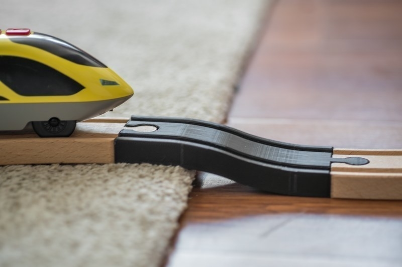 Carpet step up transition for wooden train track