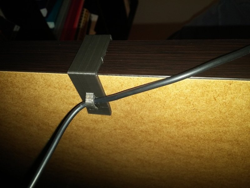 Laptop desk power cable holder