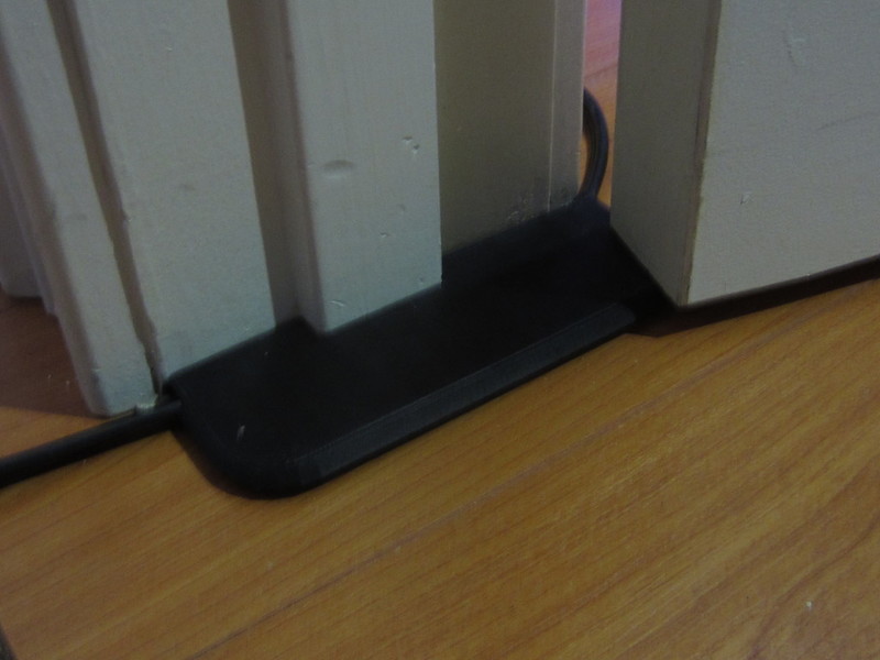 Extension cord under-door pass-thru protector 