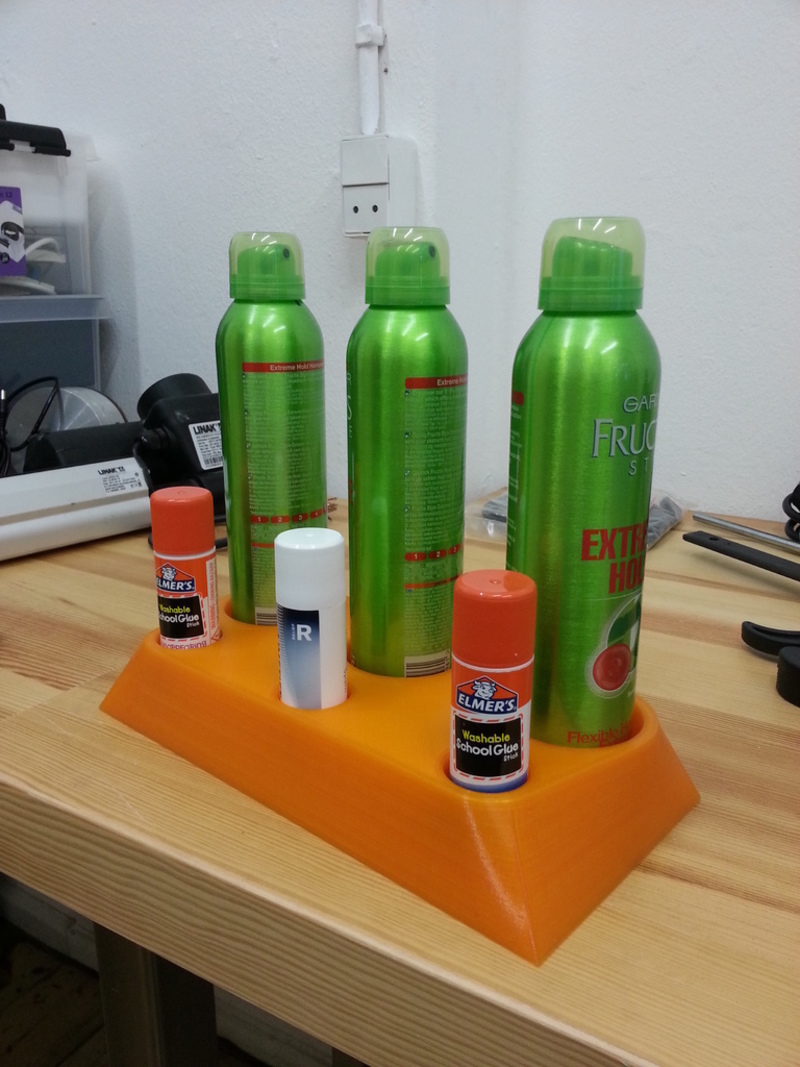 Holder for bed adhesives. 3 hairsprays and 3 glue sticks.